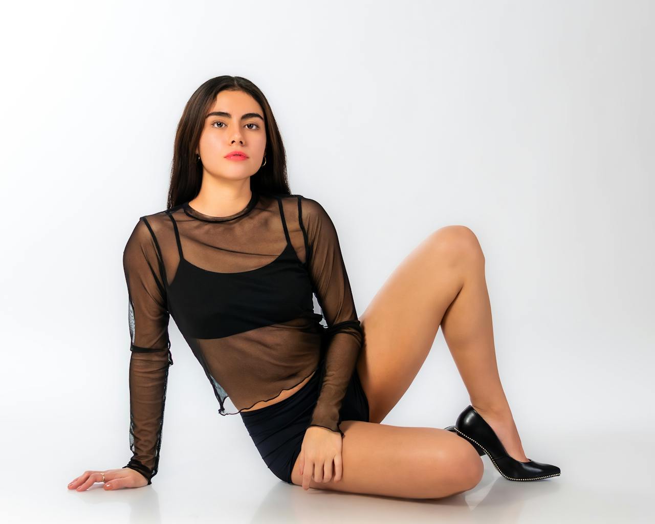 Sophisticated woman posing in elegant black outfit, showcasing style and confidence.